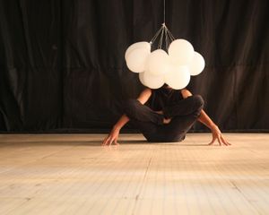 A person performing a balance pose calmly.