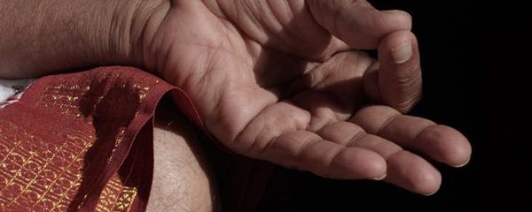 Close up of hands in a mudra position.